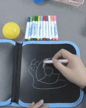 Child drawing on the magic book